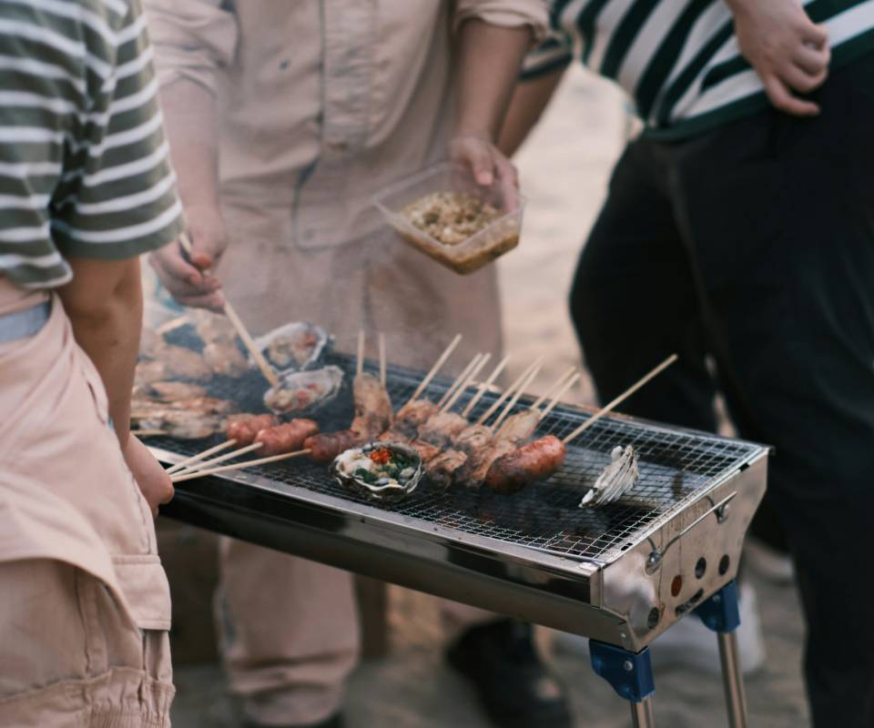 <a href="https://unsplash.com/@llliweing?utm_source=unsplash&utm_medium=referral&utm_content=creditCopyText">LI WEIBIN</a> on <a href="https://unsplash.com/photos/a-group-of-people-standing-around-a-grill-with-food-on-it-5NaylgIC3KE?utm_source=unsplash&utm_medium=referral&utm_content=creditCopyText">Unsplash</a>